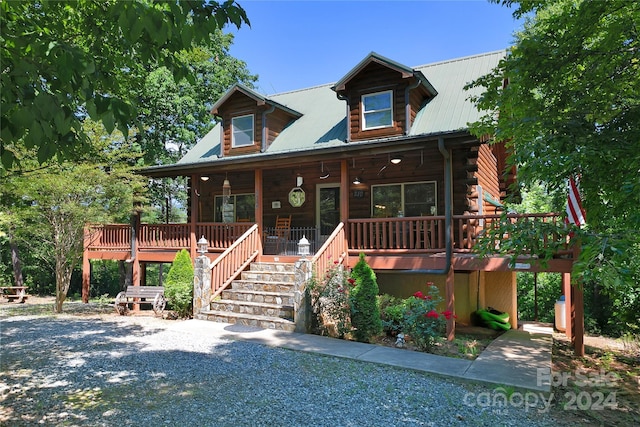 log-style house featuring a porch