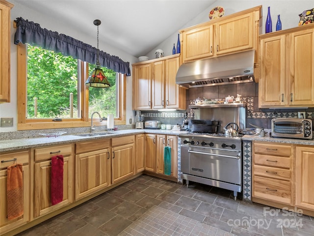 kitchen with decorative light fixtures, backsplash, vaulted ceiling, and designer range