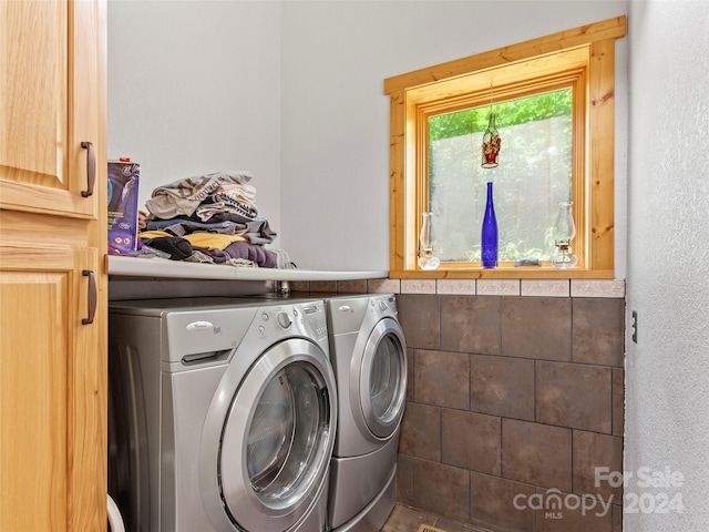 laundry area with tile walls and washing machine and dryer