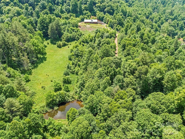 aerial view with a forest view and a water view