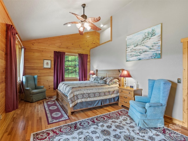 bedroom featuring wood-type flooring, vaulted ceiling, wooden walls, and ceiling fan