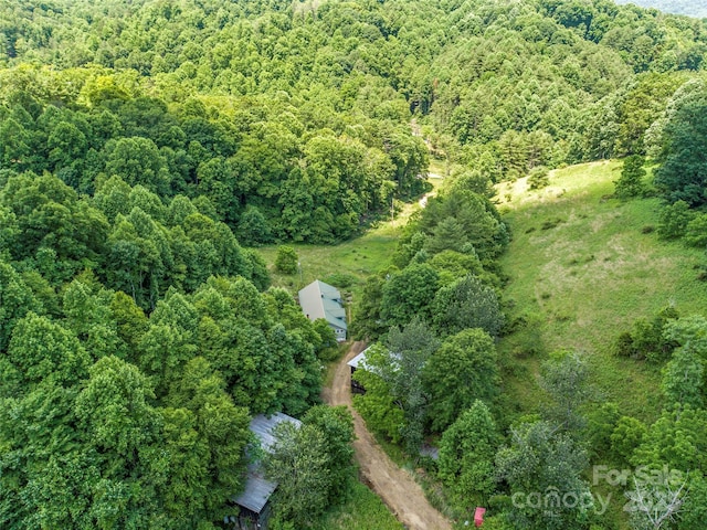 birds eye view of property featuring a wooded view