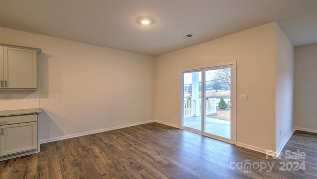 unfurnished dining area featuring dark hardwood / wood-style floors