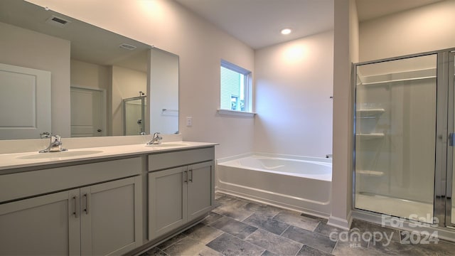 bathroom featuring plus walk in shower and vanity