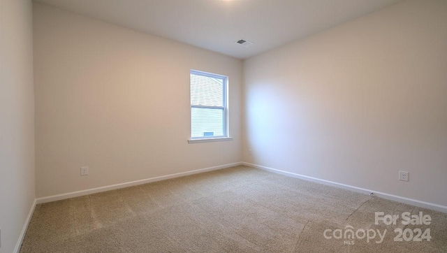 unfurnished room with light colored carpet