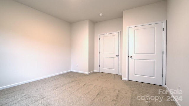 unfurnished bedroom with light carpet