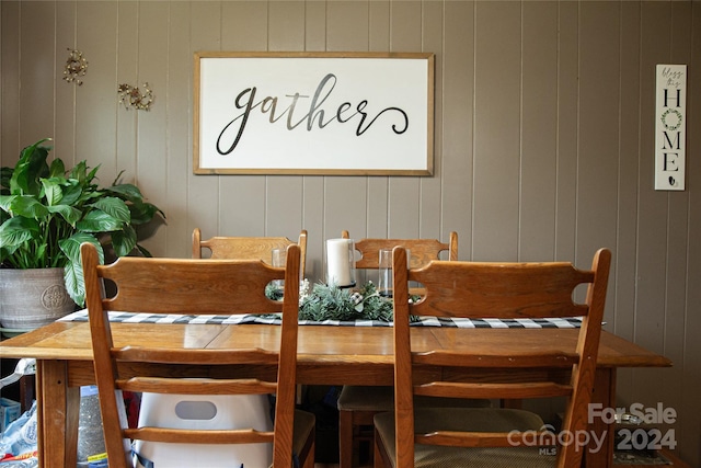 dining space with wood walls