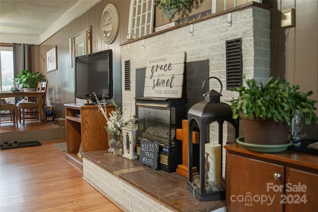 interior details featuring hardwood / wood-style flooring, a textured ceiling, and wooden walls