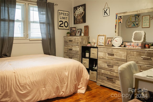 bedroom with dark hardwood / wood-style floors