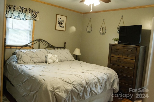 bedroom with ceiling fan and ornamental molding