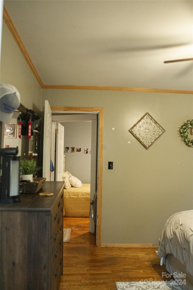 bedroom with dark hardwood / wood-style floors and crown molding