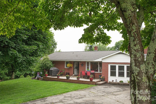 single story home with a patio area and a front yard