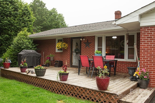 wooden deck featuring a grill