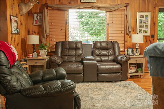 cinema room with hardwood / wood-style floors and wooden walls