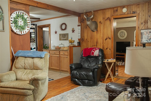 living room with wood walls and light hardwood / wood-style floors