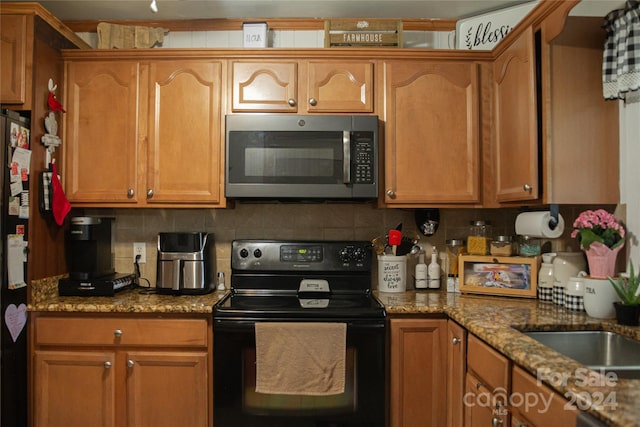 kitchen with black appliances, decorative backsplash, and light stone countertops