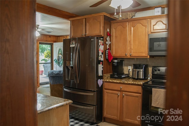 kitchen with decorative backsplash, light stone countertops, appliances with stainless steel finishes, and ceiling fan