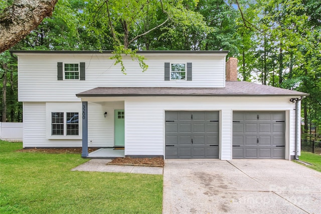 view of front property with a front lawn and a garage