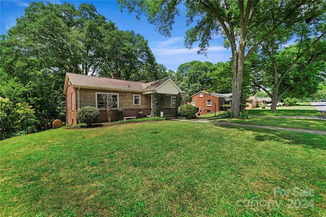 ranch-style home with a front lawn