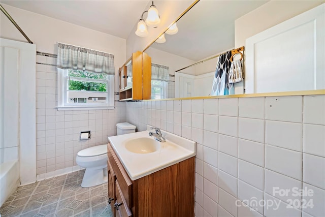 full bathroom with vanity, tile patterned flooring, toilet, shower / bath combo with shower curtain, and tile walls