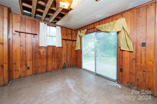 empty room featuring wooden walls