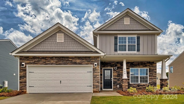 craftsman house with a porch and a garage