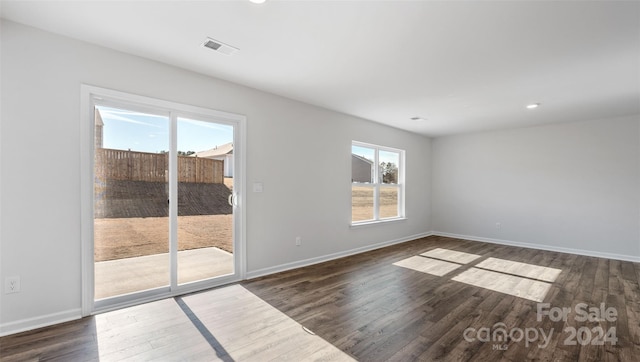 spare room featuring dark hardwood / wood-style flooring