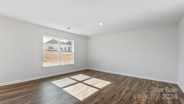 unfurnished room featuring dark hardwood / wood-style floors