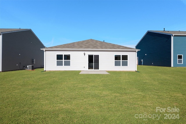 back of house with a lawn, a patio, and central AC