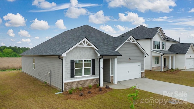 view of front of house featuring a garage and a front lawn