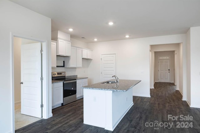 kitchen featuring stainless steel range with electric stovetop, dark hardwood / wood-style floors, white cabinets, and an island with sink