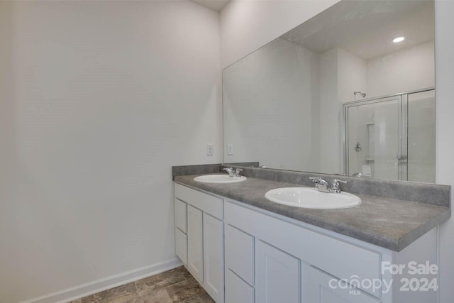 bathroom featuring vanity and a shower with shower door