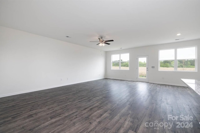 spare room with ceiling fan and dark wood-type flooring