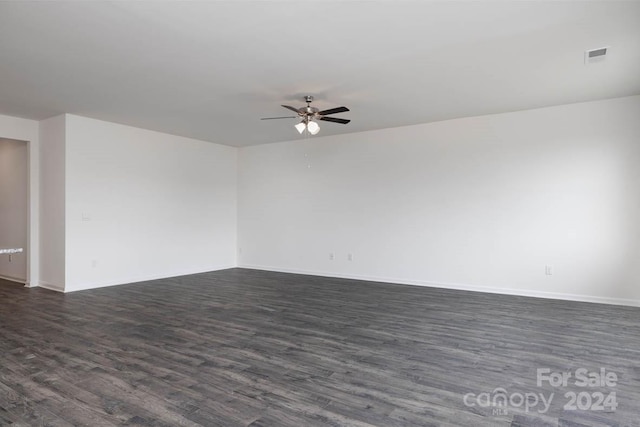 empty room featuring ceiling fan and dark wood-type flooring