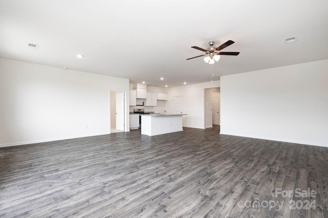 unfurnished living room with ceiling fan and wood-type flooring