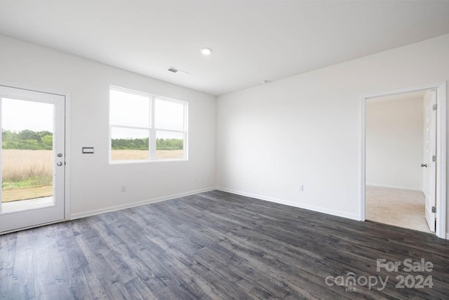 unfurnished room with dark hardwood / wood-style floors