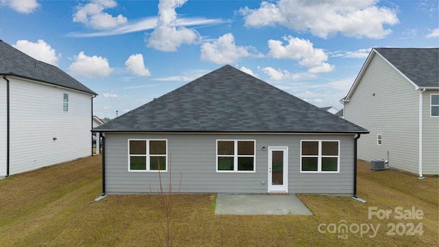 back of property featuring a yard, central AC, and a patio area