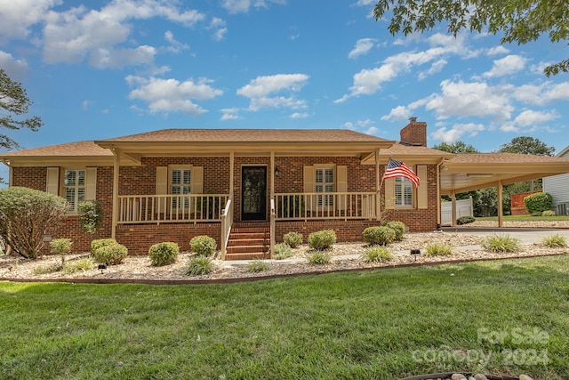 view of front of property with covered porch, a carport, and a front yard