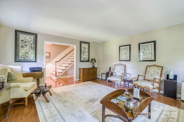 living room with hardwood / wood-style flooring and a textured ceiling