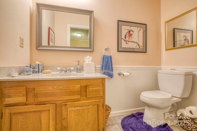 bathroom with vanity, toilet, and tile patterned floors