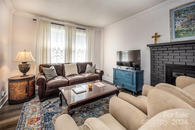 living room featuring wood-type flooring and a fireplace