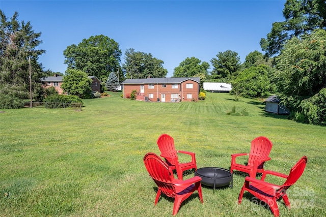 view of yard with an outdoor fire pit and a storage unit