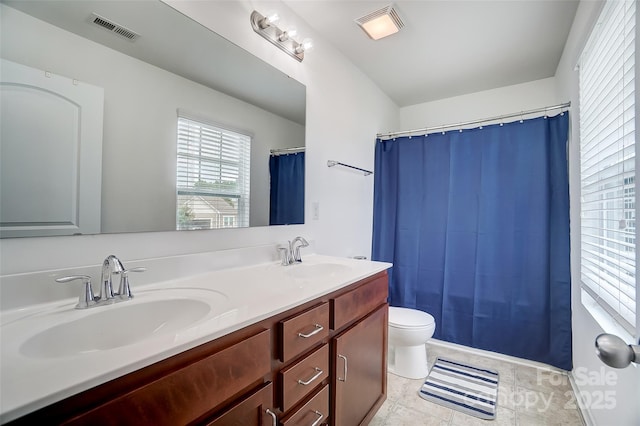 bathroom featuring tile patterned floors, vanity, and toilet