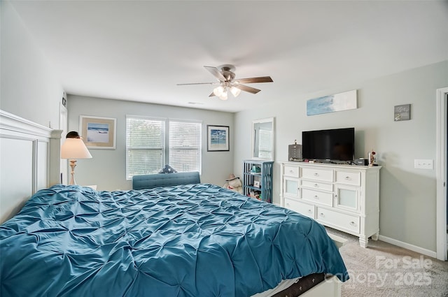 bedroom featuring ceiling fan and light carpet