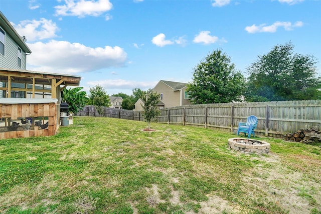 view of yard with a fire pit