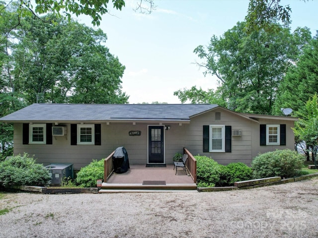 single story home with central air condition unit and a wall unit AC