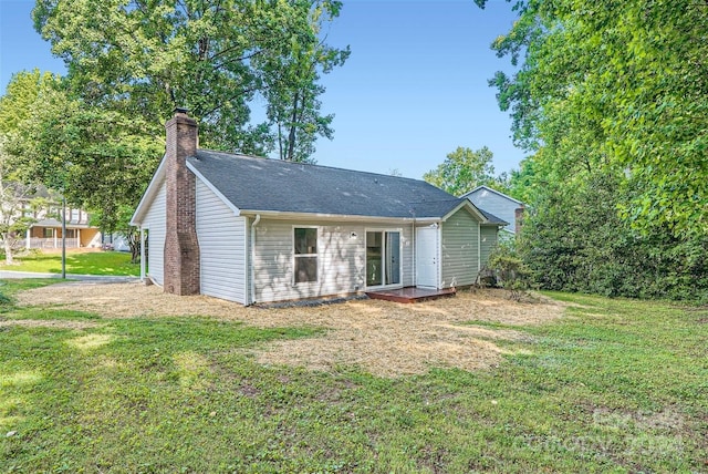 rear view of house with a yard