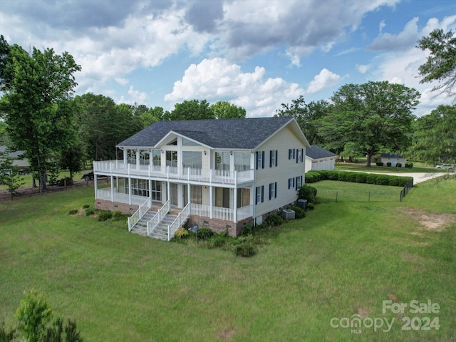 back of property featuring a lawn and a balcony