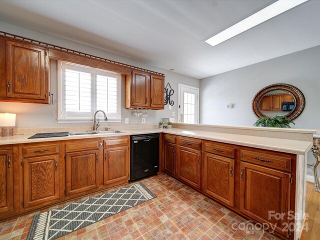 kitchen with sink, black dishwasher, and kitchen peninsula