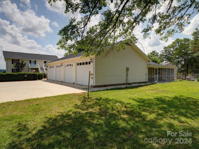 view of side of home with a lawn